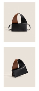 Detail of contrast color leather crossbody bag featuring a wide handle and metal rings