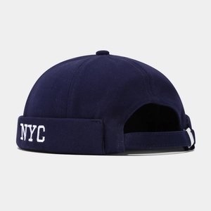 Detail view of the navy blue NYC docker cap featuring adjustable back strap and metal buckle