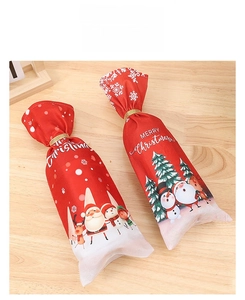 Detail of Christmas wine bottle covers with Santa and reindeer prints and gold ties
