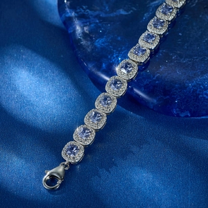 Macro detail of S925 silver bracelet featuring light blue square-cut cubic zirconia gems