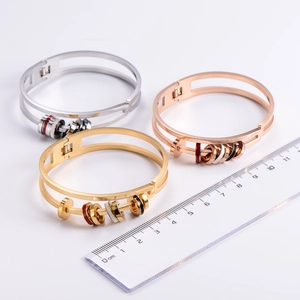 Detailed scale view of hollow double-layer steel bangles in gold, silver, and rose gold
