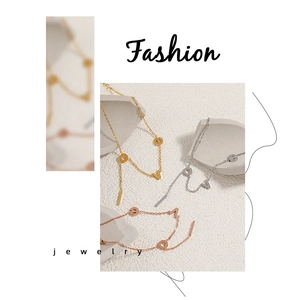 Detailed macro view of LOVE letter anklets in gold, silver, and rose gold finishes