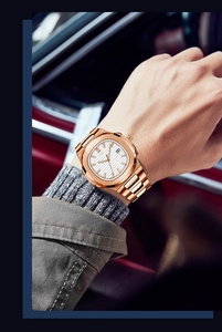 Detailed close-up of rose gold square quartz watch with white textured dial and date display
