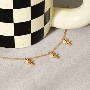 Elegant gold stainless steel bracelet with three white pearls and cross pendants for women