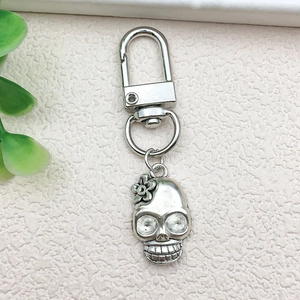 Macro view of vintage silver skeleton keychain with floral details and metal lobster clasp