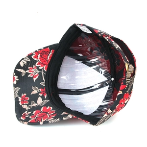 Internal detail of a floral baseball cap featuring a metal buckle and soft sweatband