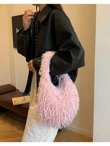 Pink plush hobo bag with tassel detail worn by model for 2025 autumn fashion style