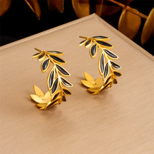 Vintage golden leaf earrings with black enamel detail in a minimalist C-shape design