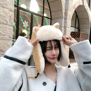 Winter plush cat ear trapper hat for women in beige and brown faux fur on a female model