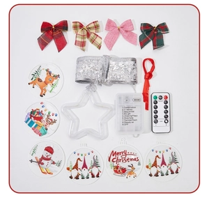 Flat lay of Christmas ribbon light set including LED controller, bows, and festive charms
