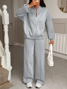 Detail of grey casual two-piece lounge set with zip-up hoodie and wide-leg trousers