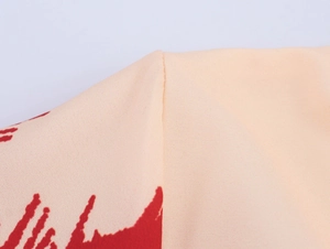 Close-up of high-quality stitching and palm print texture on summer dress fabric