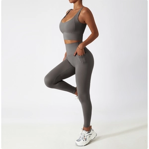 Side view of dark grey high-waisted yoga pants with side pockets and matching crop top