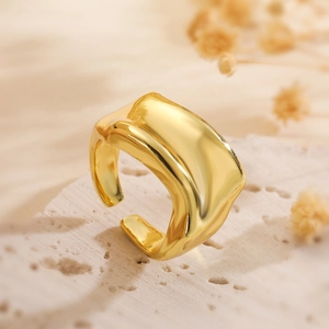 Irregular wide gold twisted ring with minimalist geometric design on natural stone