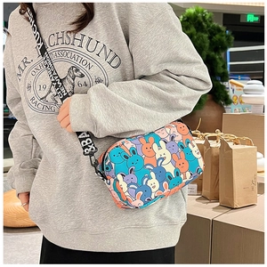 Detailed shot of a cartoon bunny crossbody bag with a branded wide shoulder strap