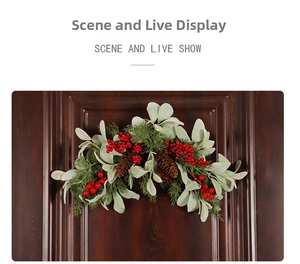 Detail of Christmas door swag with red berries, pine cones, and green leaves on wood
