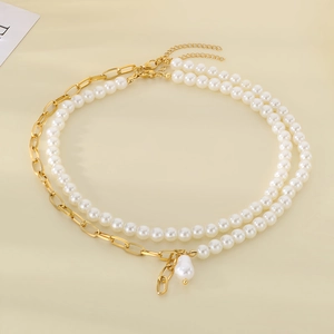 Detail of double-layer baroque pearl and gold stainless steel chain with drop pendant