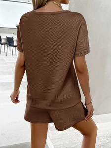Detail view of brown two-piece knit set featuring geometric texture and modern casual style