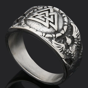 Detail of vintage silver Viking ring with Valknut symbol and raven embossed motifs