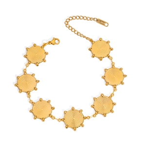 Detailed view of a gold stainless steel bracelet featuring spiral textured charms and clasp
