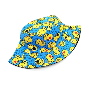 Flat lay of bright blue bucket hat with yellow duck patterns and breathable cotton fabric