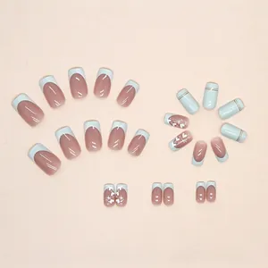 Blue French tip press-on nails with heart and gold foil star patterns for women