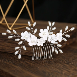 Handmade bridal hair comb with white clay flowers and pearls on a silver wire branch