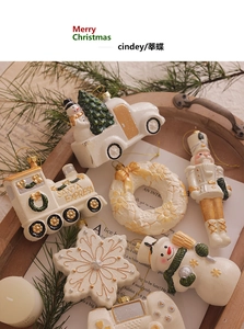 Close-up of vintage cream Christmas ornaments with golden details and rustic pine branches