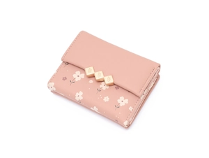 Detailed macro view of a pink floral trifold wallet featuring a golden leaf metal snap