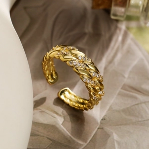 Braided 18K gold plated ring with sparkling cubic zirconia in an open adjustable design