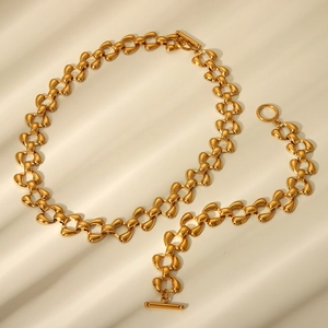 Detailed view of a gold stainless steel hip hop chain belt with T-bar and ring closure