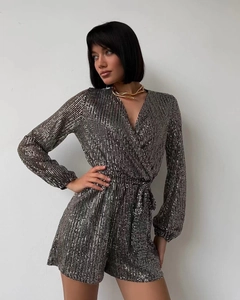 Detail of shimmering black and silver sequins on a V-neck long sleeve sequin romper