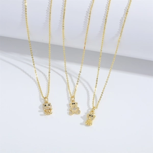 Elegant gold bear pendant necklaces with shimmering cubic zirconia on a white background