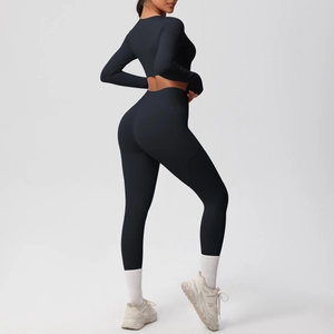 Side view of matte black high-waist yoga leggings with side pockets and cropped top