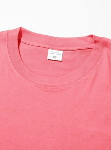 Macro shot of pink cotton T-shirt neckline with size M tag and neat stitching details