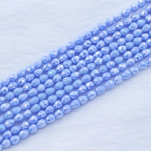 Macro shot of faceted ice blue strawberry teardrop beads for DIY jewelry making
