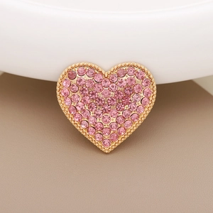 Detailed view of pink rhinestone heart charm with gold base for DIY shoe and phone accessories