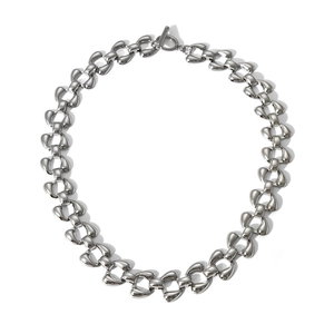 Detailed close-up of a silver stainless steel link necklace with unique T-bar toggle clasp