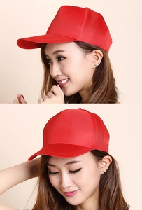 Profile view of a solid red cotton baseball cap on a model with minimalist background