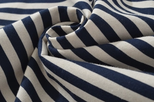 Macro detail of blue and white striped knit fabric showing soft texture and fine stitching