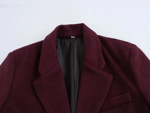 Detail of burgundy wool suit blazer with notch lapels and black satin lining