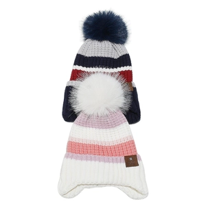 Detail of colorful striped knitted kids beanies with thick faux fur pom-poms and star tags