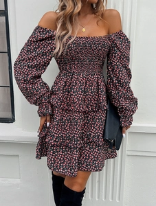Detail of the off-shoulder floral dress featuring a smocked bodice and tiered ruffled hem