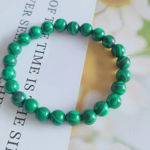 Close-up of 8mm green malachite bead bracelet with natural dark stripes and smooth finish