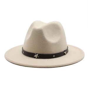 Close-up of beige fedora hat featuring a brown leather band with metallic star studs