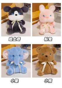 Detail view of plush husky, rabbit, elephant, and bear toys with branded silk ribbons