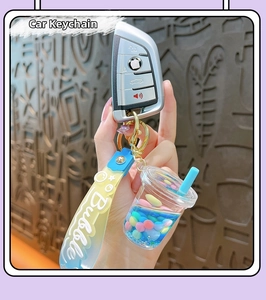 Detail of creative bubble tea cup keychain with blue liquid and silicone wristlet