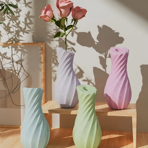 Set of four pastel macrame spiral vases in blue, purple, green, and pink colors