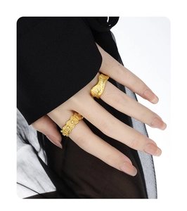 Detailed shot of irregular matte gold rings with micro-inlaid diamonds on a model