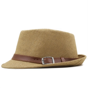 Detail of khaki straw fedora hat featuring a brown leather band and square metal buckle